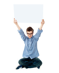 Image showing Young kid holding empty placard over his head