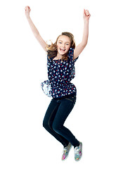 Image showing Young girl jumping in excitement