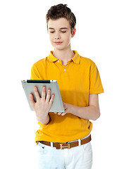 Image showing Portrait of a cute boy using a portable device
