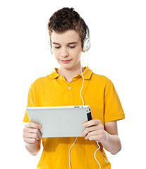 Image showing Boy listening to music on tablet pc