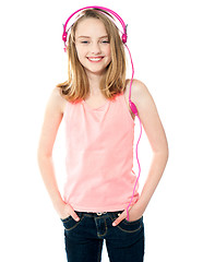 Image showing Pretty girl enjoying music through headphones