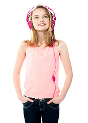 Image showing Adorable girl tuned into music