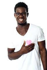 Image showing Handsome man holding paper heart