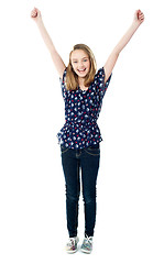 Image showing Excited school girl with raised arms