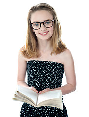 Image showing Cute little girl standing with an open book