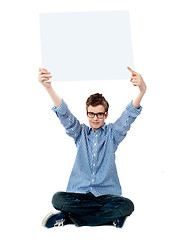 Image showing Boy pointing towards white blank billboard