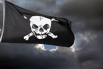 Image showing Jolly Roger (pirate flag) against storm clouds