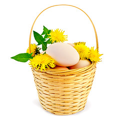 Image showing Eggs in a basket with dandelions