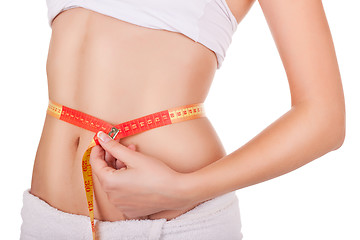 Image showing young woman's waist wrapped in a tape measure