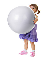 Image showing Little girl has a huge ball on white background