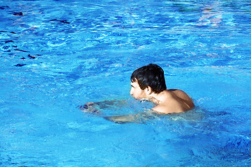 Image showing young swimmer in blue water