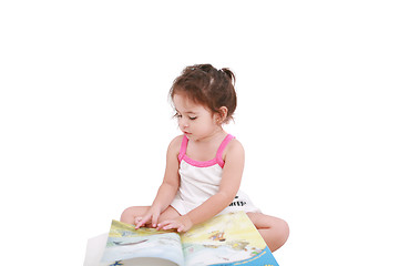 Image showing Beautiful toddler girl reading a book 