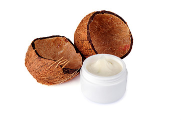 Image showing Coconut shells and a jar of cream