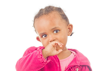 Image showing Playful little girl with a finger in her mouth