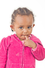 Image showing Playful little girl with a finger in her mouth