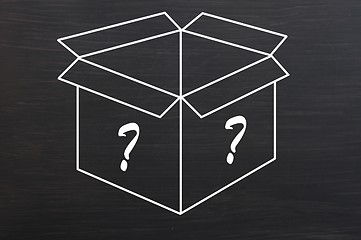 Image showing Open box with question marks drawn on smudged blackboard