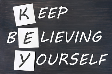 Image showing Acronym of KEY for Keep Believing Yourself written in chalk on a blackboard