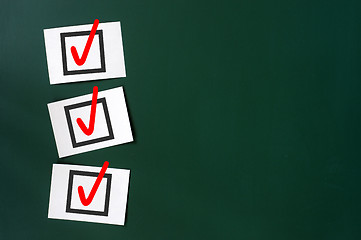 Image showing Check box with red tick on a green chalkboard