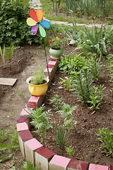 Image showing Various old objects decorate the garden