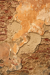 Image showing Old brick wall with ragged plaster
