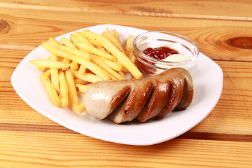 Image showing grilled sausages with French fries and ketchup