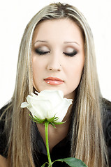 Image showing beautiful young blond woman with a flower in her hands