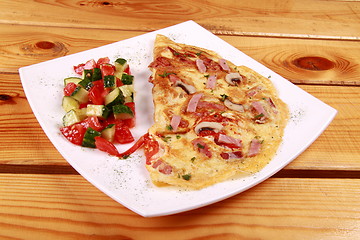 Image showing Omelet with prosciutto ham and rocket salad.