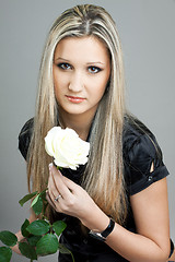 Image showing beautiful young blond woman with a flower in her hands