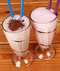 Image showing two cocktails with straw on wooden background