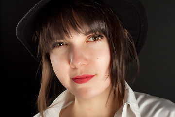 Image showing young beautiful girl on black hat