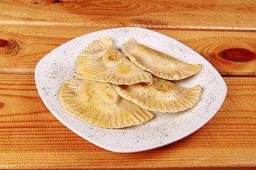 Image showing Cooked raviolli on a shiny white plate