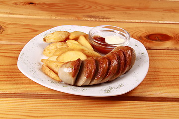 Image showing grilled sausages with French fries and ketchup