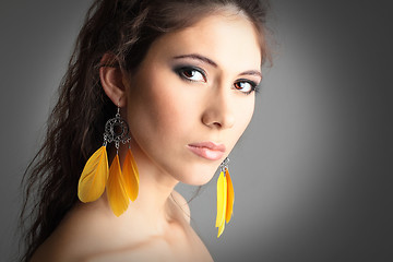 Image showing cute girl with beautiful yellow earrings