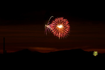 Image showing Firecrackers In The Sky During Sunset