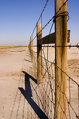 Image showing Wire and Wooden Fence Under Clear Skies