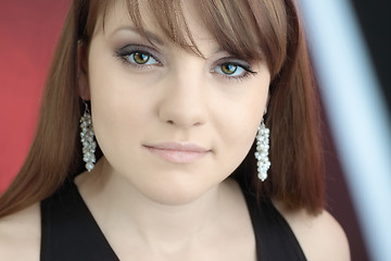 Image showing face of a beautiful brunette with cute earrings