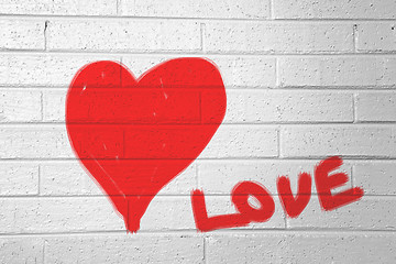 Image showing Red heart on the white wall and text 