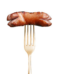 Image showing Grilled sausage on a fork isolated on white background