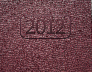 Image showing Year 2012 text on leather background