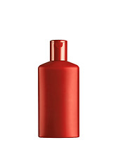 Image showing red cosmetic bottle isolated on the white