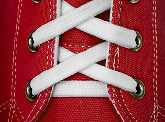 Image showing White lace on red sneakers