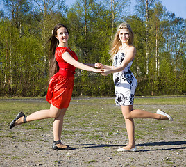 Image showing Two girls dancing in the park