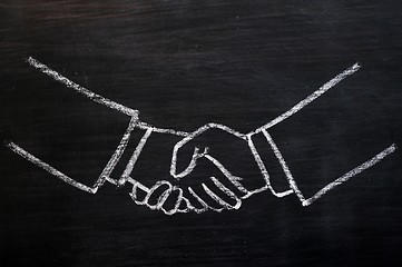 Image showing Chalk drawing of handshaking on a blackboard