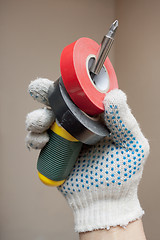 Image showing Hand holding screwdriver and electrical tape