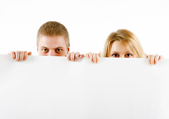 Image showing boy and a girl peeking from a sheet