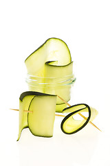 Image showing Pile of sliced zucchini pieces arranged on white background