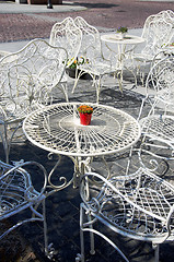 Image showing Decorative white tables and chairs outside cafe 