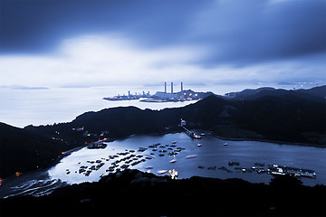 Image showing Power station at night with mountain landscape