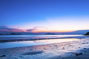 Image showing Sunset coast with reflection of clouds