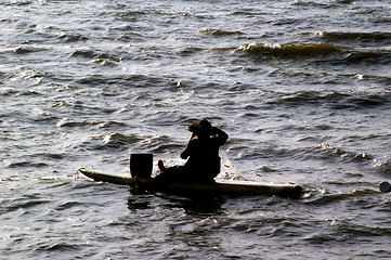 Image showing Fisherman on the sea catching fishes